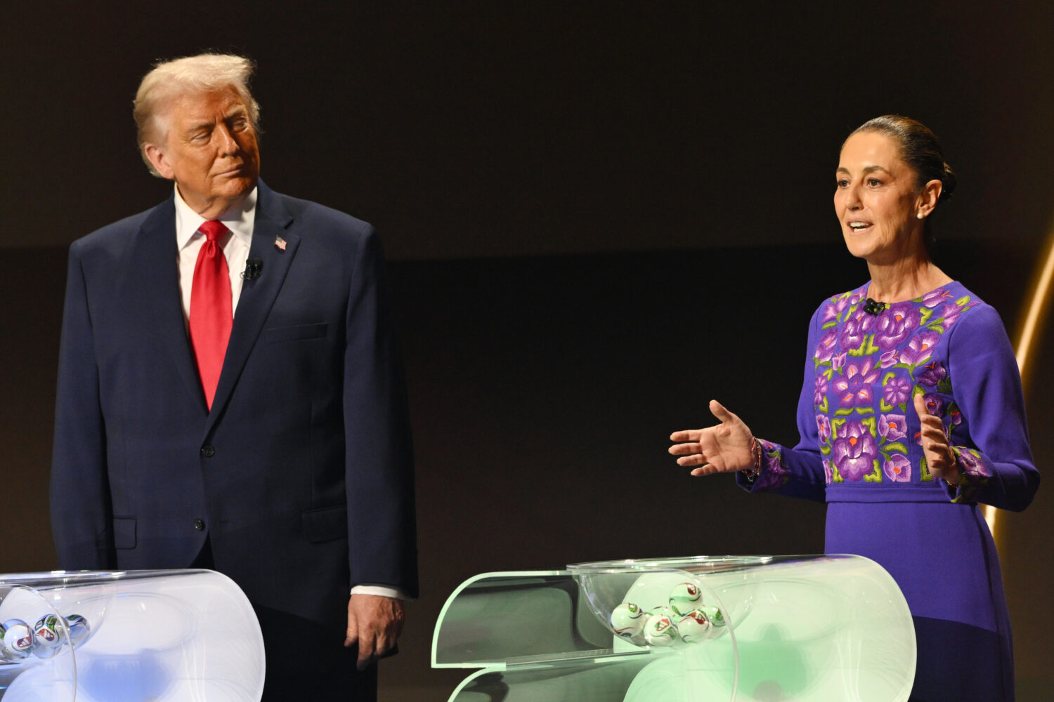FILE - U.S. President Donald Trump looks on as Mexican President Claudia Sheinbaum speaks on stage ...