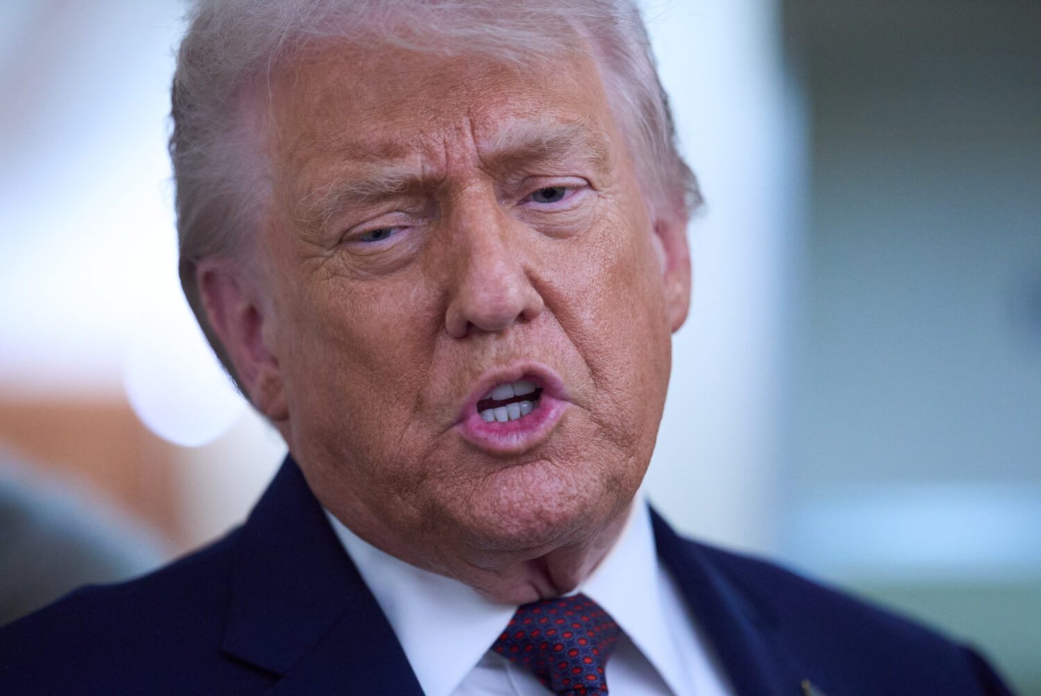 President Donald Trump speaks with reporters aboard Air Force One after leaving the World Economic ...