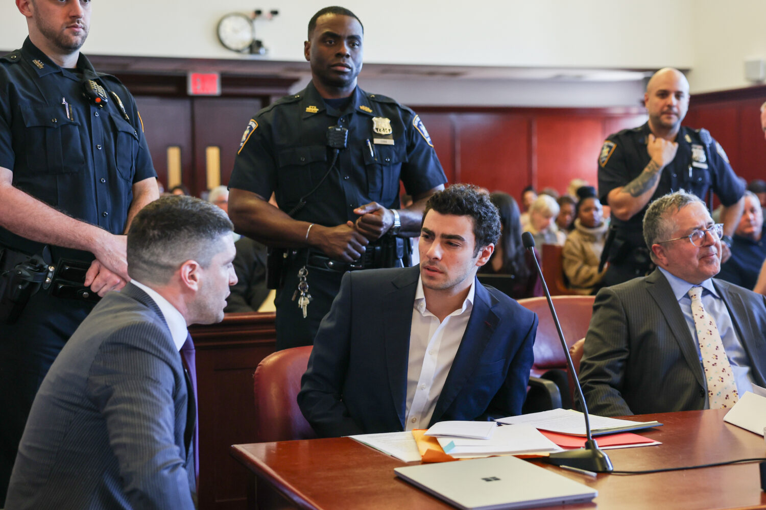 FILE - Luigi Mangione appears in Manhattan Criminal Court for an evidence hearing, Dec. 18, 2025, i...