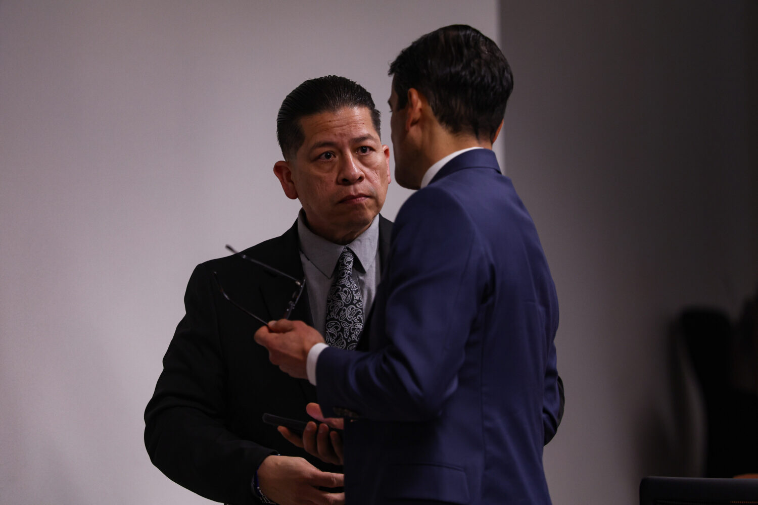 Former Uvalde school district police officer Adrian Gonzales, left, talks to his defense attorney N...