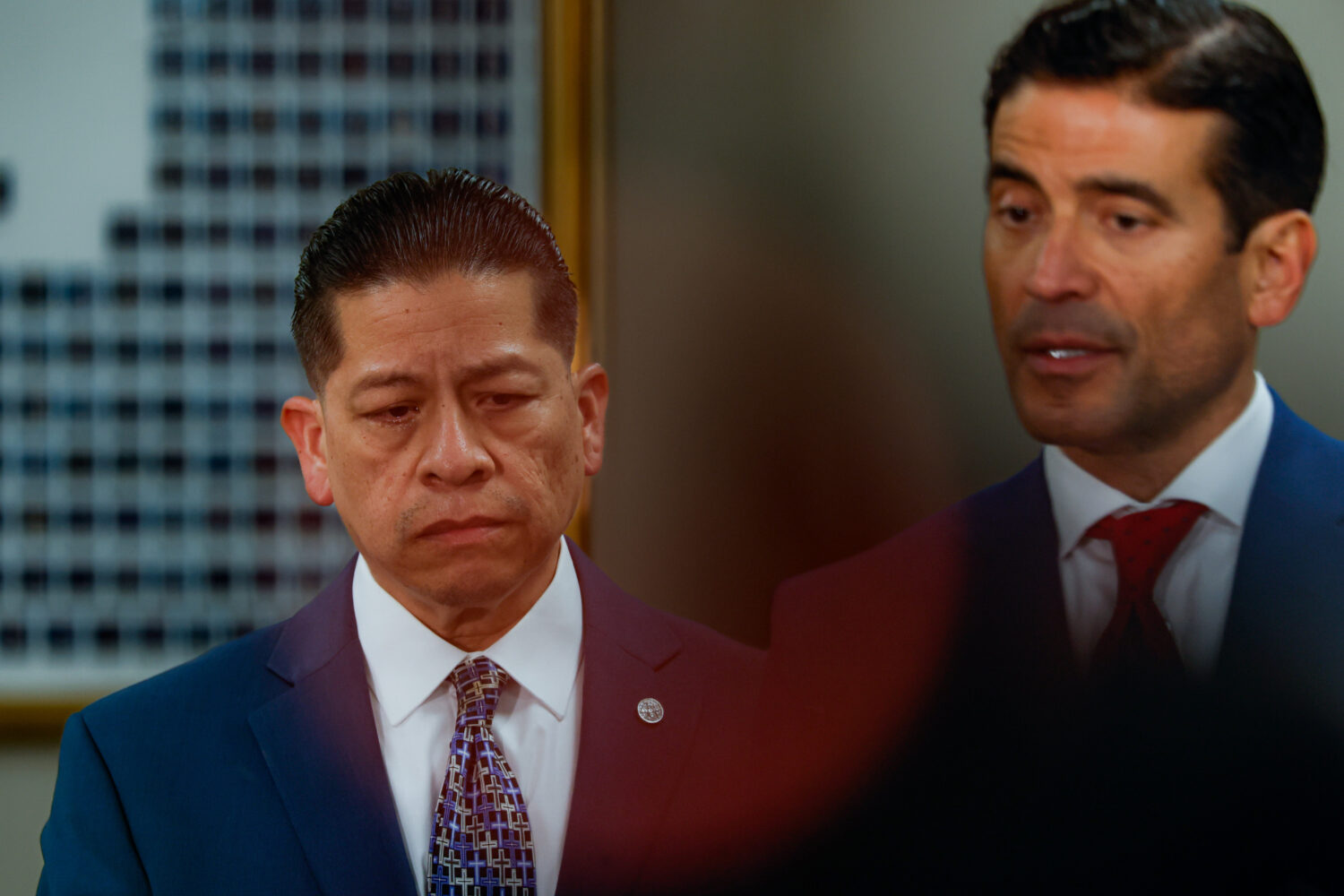 Former Uvalde school district police officer Adrian Gonzales, left, reacts as he stands beside his ...