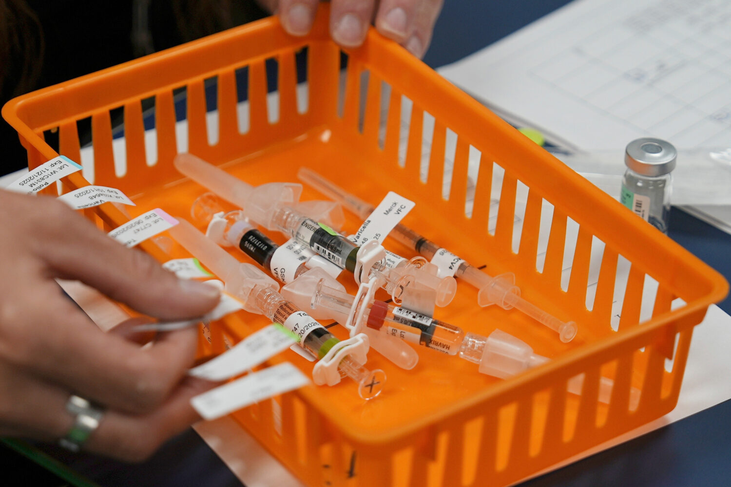 FILE - Vaccines are prepared for students during a pop-up immunization clinic at a school in Louisv...