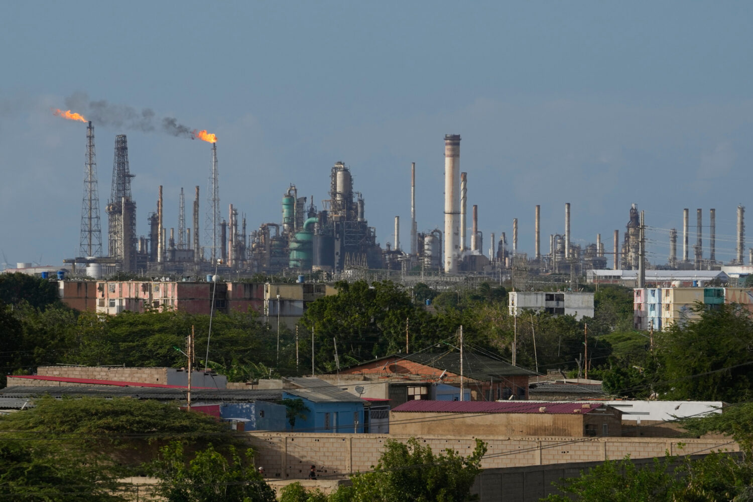 Flames rise from flare stacks at the Amuay refinery in Los Taques, Venezuela, Wednesday, Jan. 14, 2...