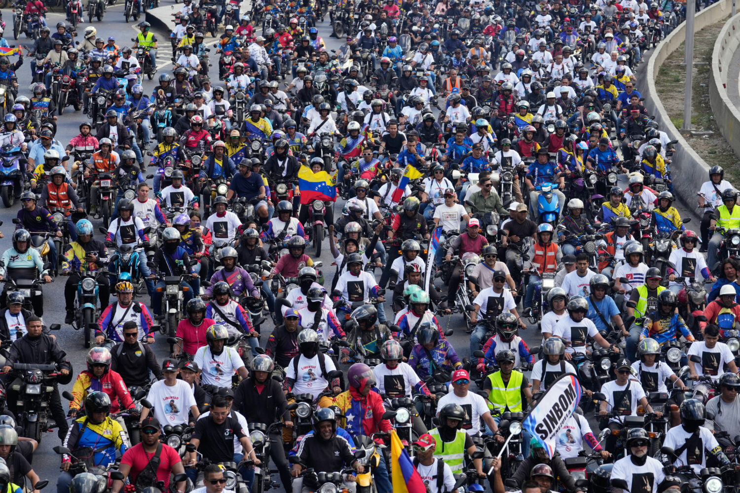 Supporters of former Venezuelan President Nicolas Maduro ride through the streets calling for his r...