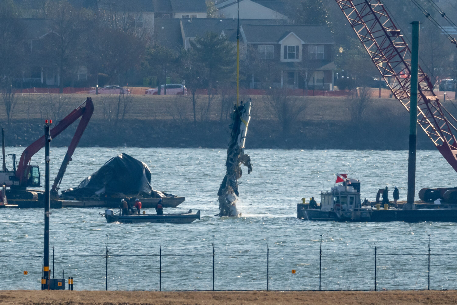 FILE - A piece of wreckage is lifted from the water onto a salvage vessel near the site in the Poto...