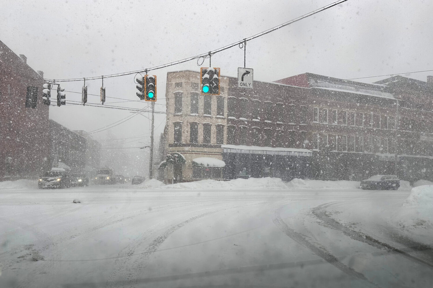 Fresh snow blows through an intersection in Lowville, N.Y., on Thursday, Jan. 22, 2026. (AP Photo/C...