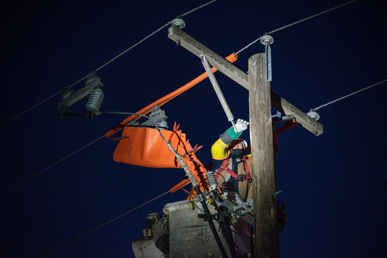 FILE - Oncor apprentice lineman Brendan Waldon repairs a utility pole that was damaged by a winter ...