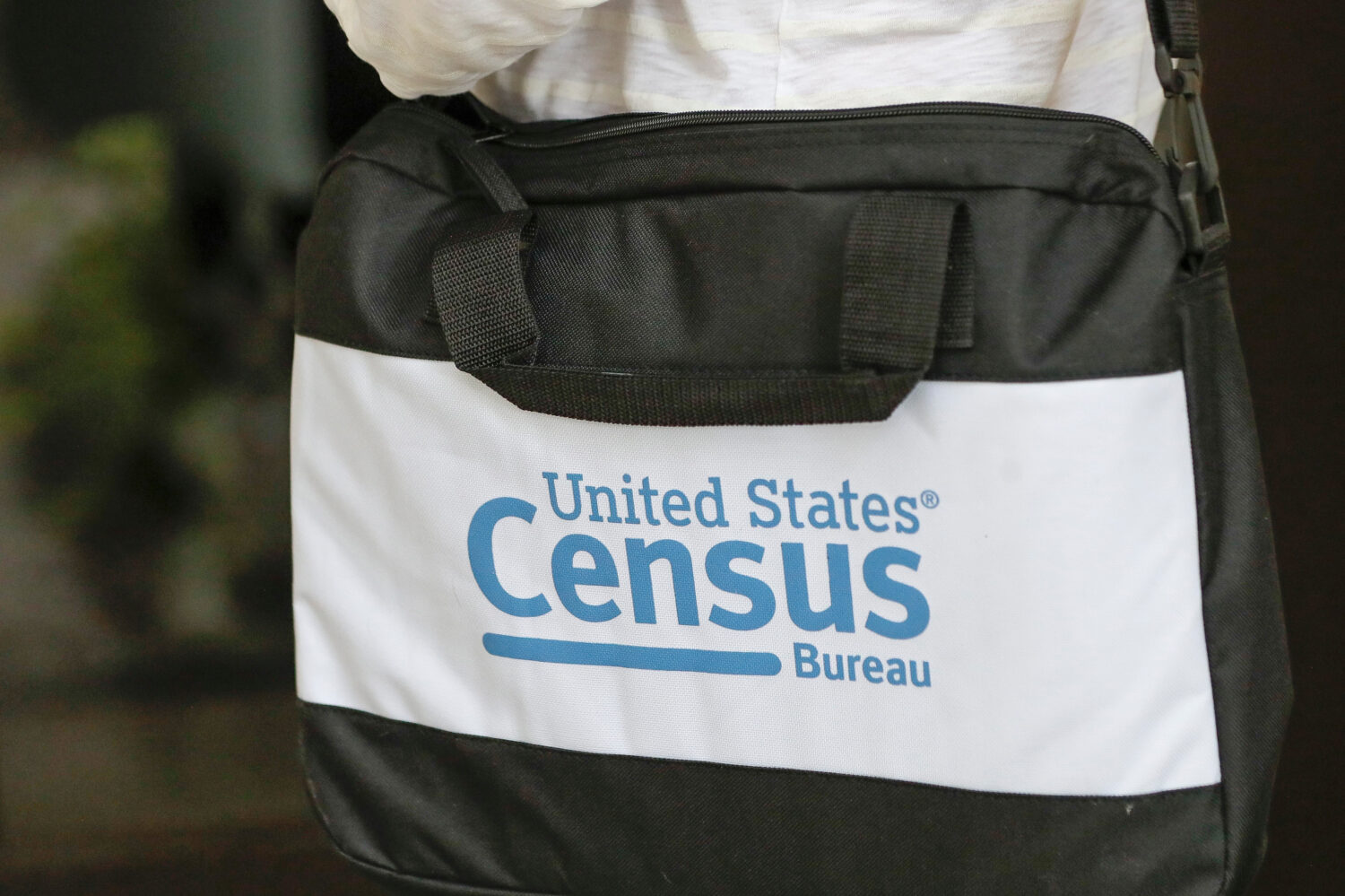 FILE - A briefcase of a census taker is seen as she knocks on the door of a residence, Aug. 11, 202...