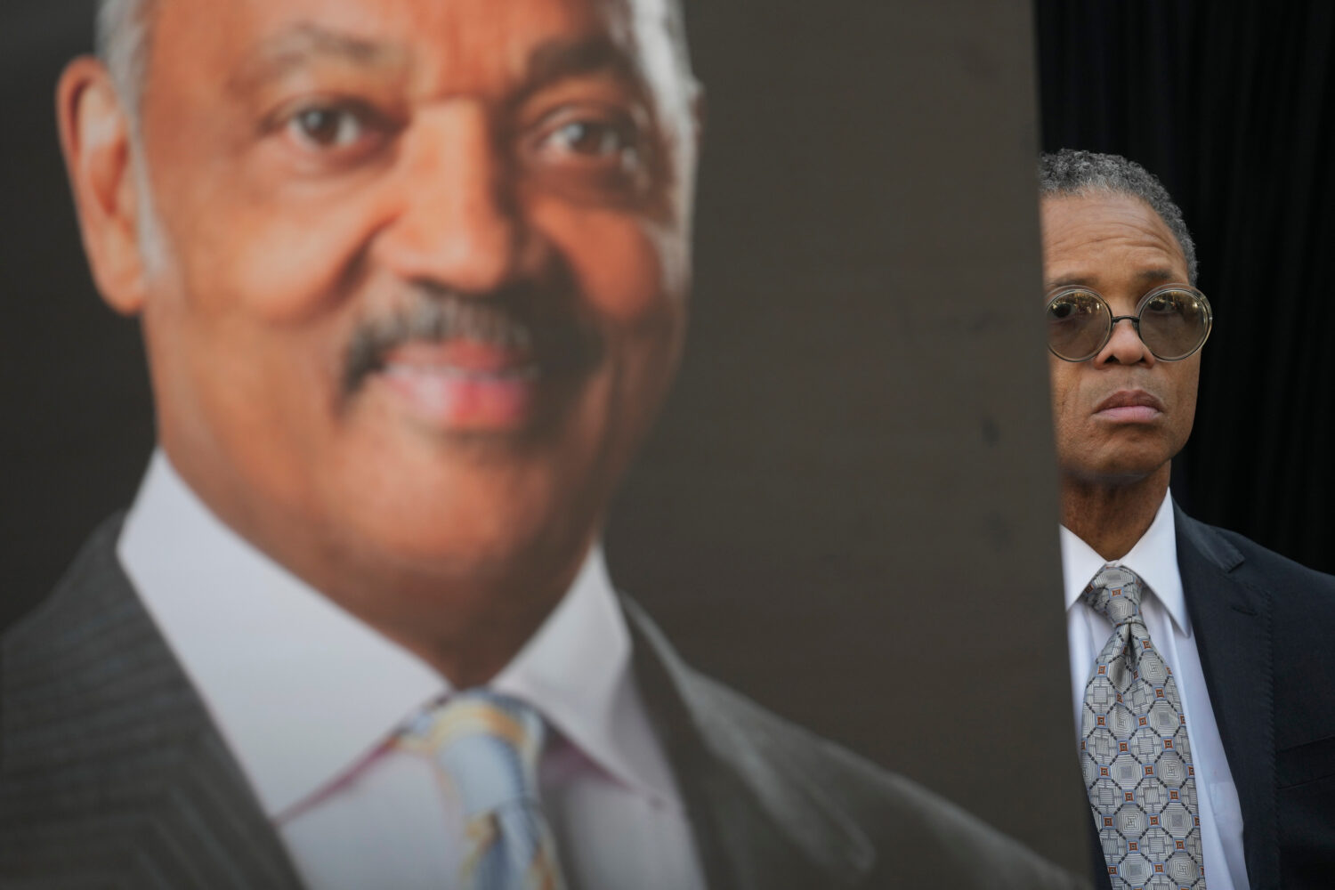 Jesse Jackson, Jr. stands near a picture of his father, the late Rev. Jesse Jackson, during a news ...