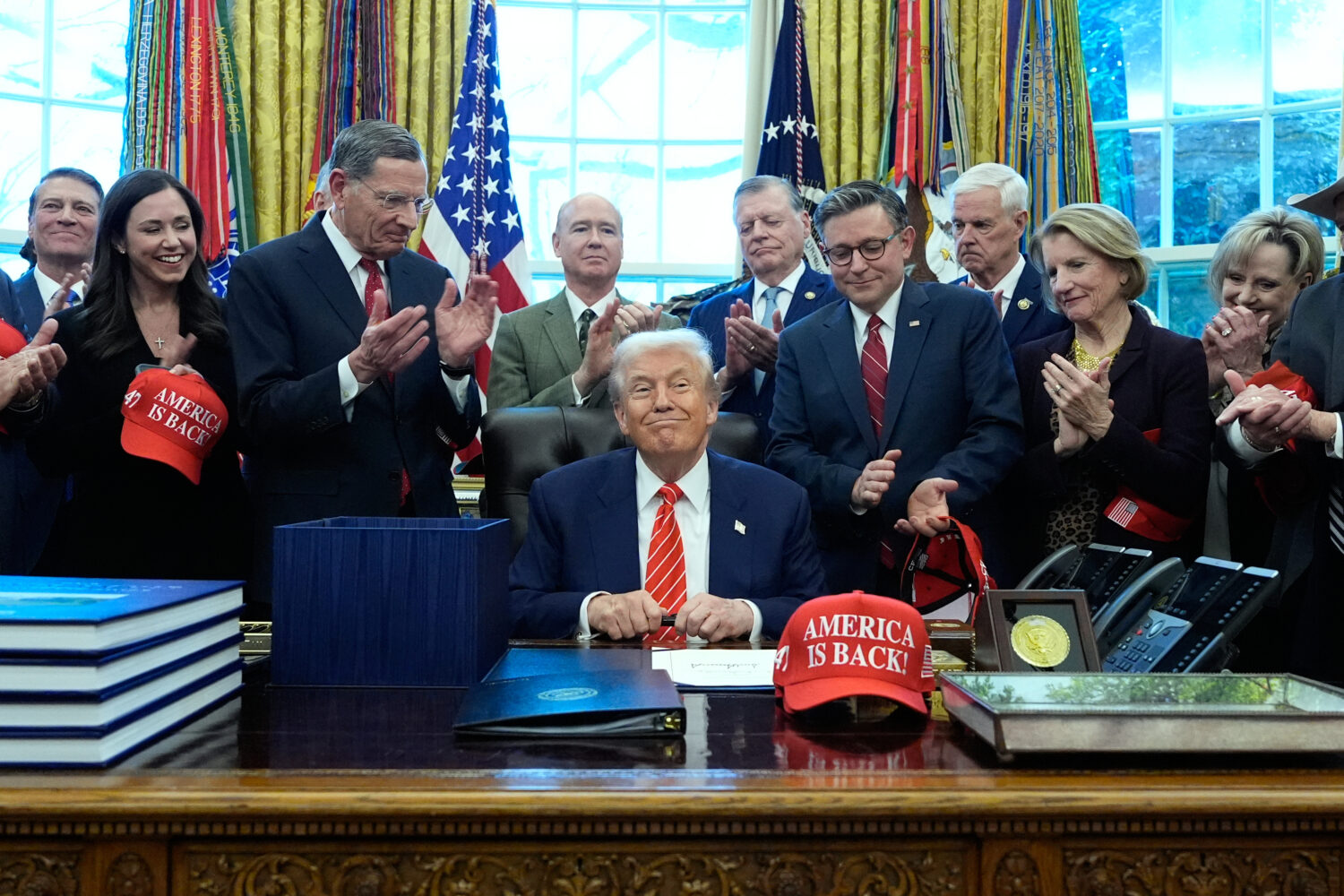 President Donald Trump smiles after signing a spending bill that ends a partial shutdown of the fed...