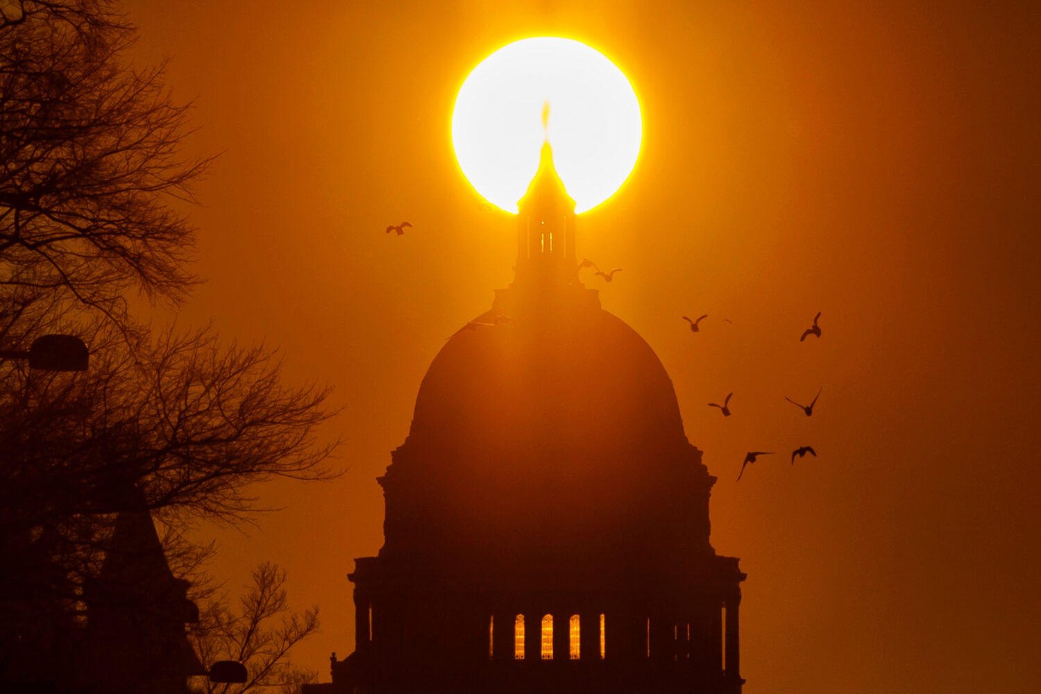 FILE - Birds fly near the U.S. Capitol during sunrise, Feb. 13, 2026, in Washington. (AP Photo/Tom ...