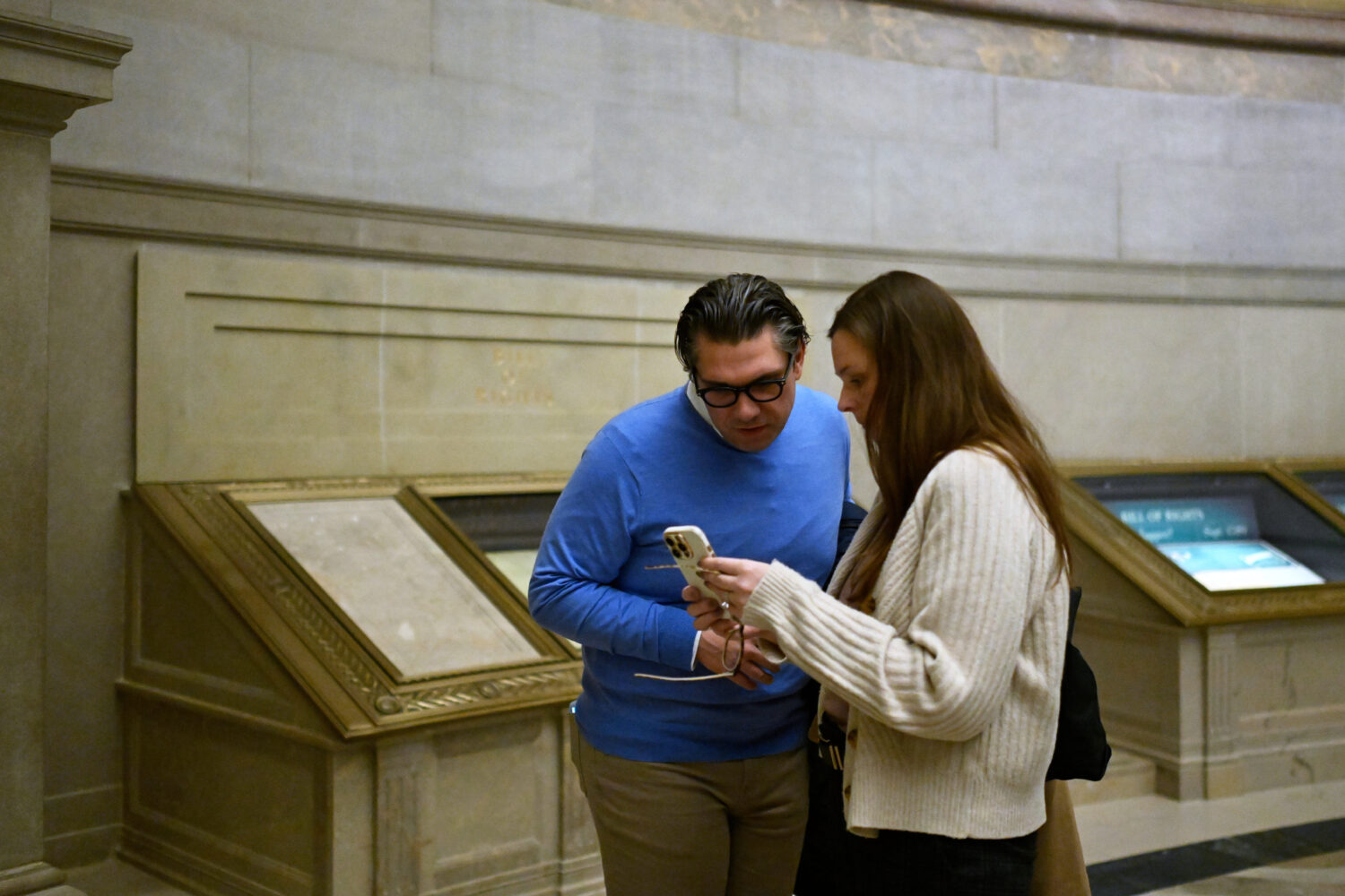 Ryan O'Neil, left, and Kate Weaver of West Bloomfield, Mich., look at a photo that they took of the...