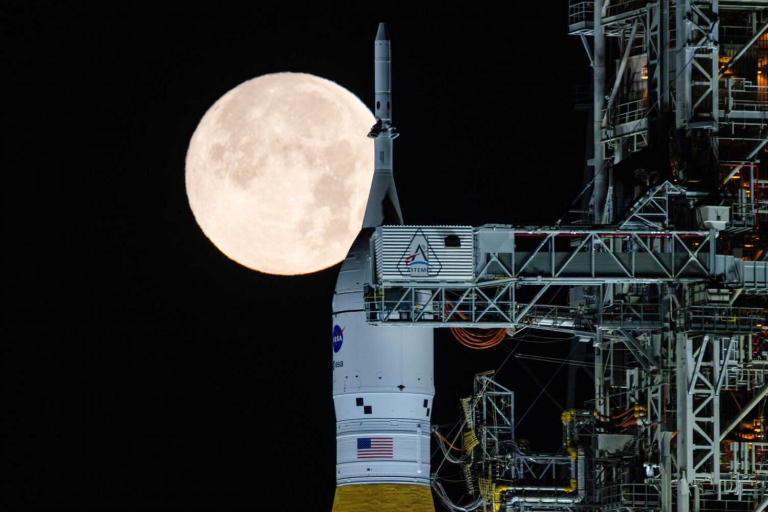 FILE - A full moon is seen shining over NASA's SLS (Space Launch System) and Orion spacecraft, atop...