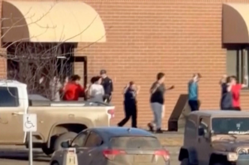 This grab from video shows students exiting the Tumbler Ridge school after deadly shootings, in Bri...