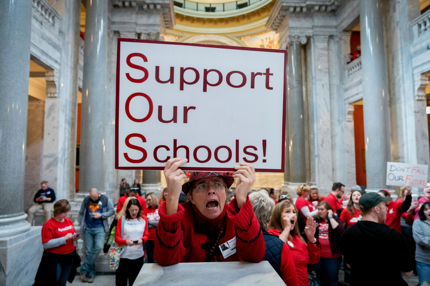 FILE - Karen Schwartz, a teacher at Phoenix School of Discovery in Louisville, stands with other te...