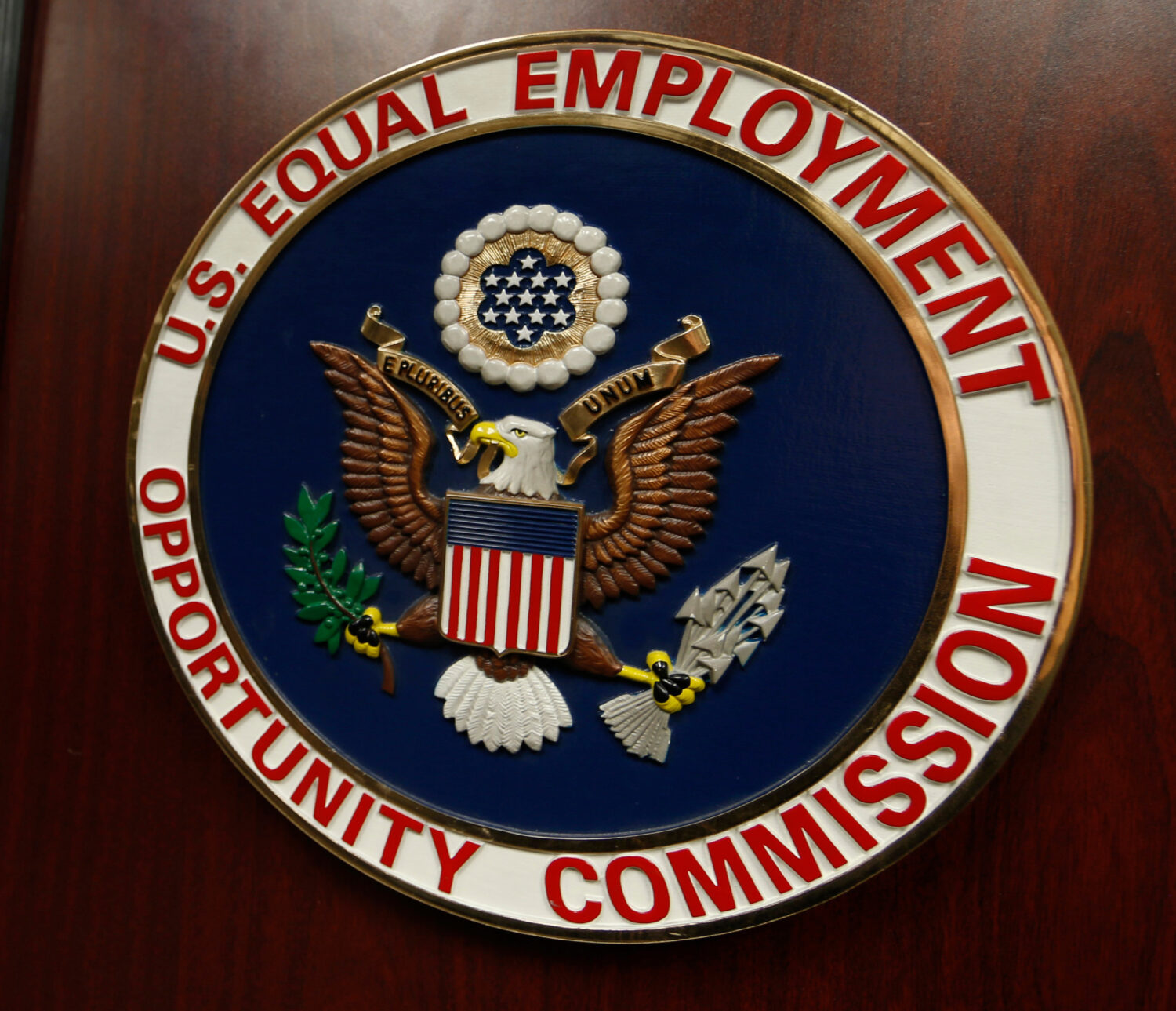 FILE - The emblem of the U.S. Equal Employment Opportunity Commission (EEOC) is displayed on a podi...