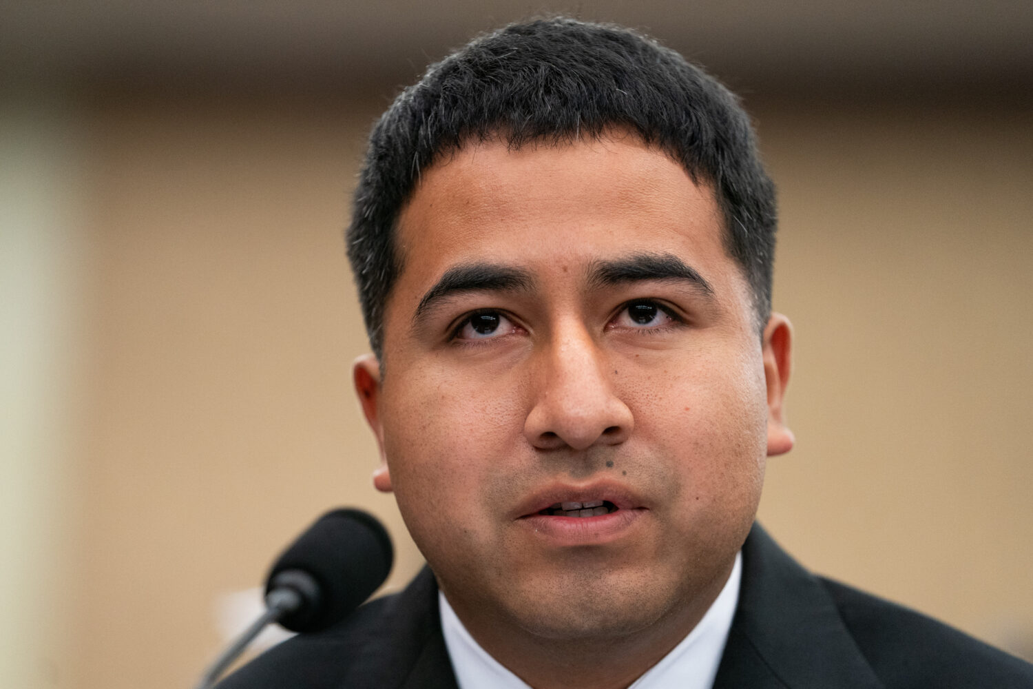 Alejandro Barranco, the son of a man detained by Immigration and Customs Enforcement, speaks at a D...