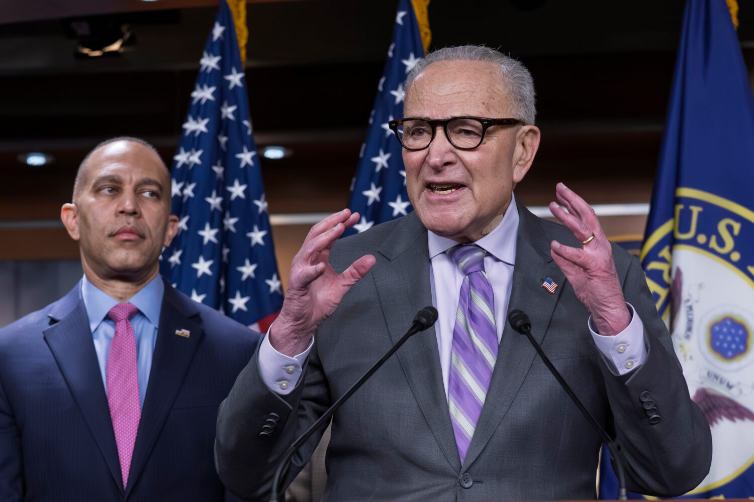 Senate Minority Leader Chuck Schumer, D-N.Y., center, speaks during a news conference as House Mino...