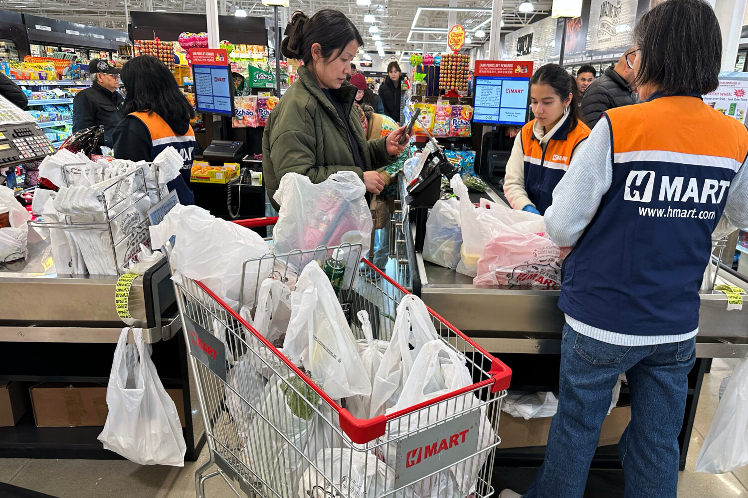 A shopper checks out at a cash register in a grocery store in Schaumburg, Ill., Monday, Feb. 9, 202...