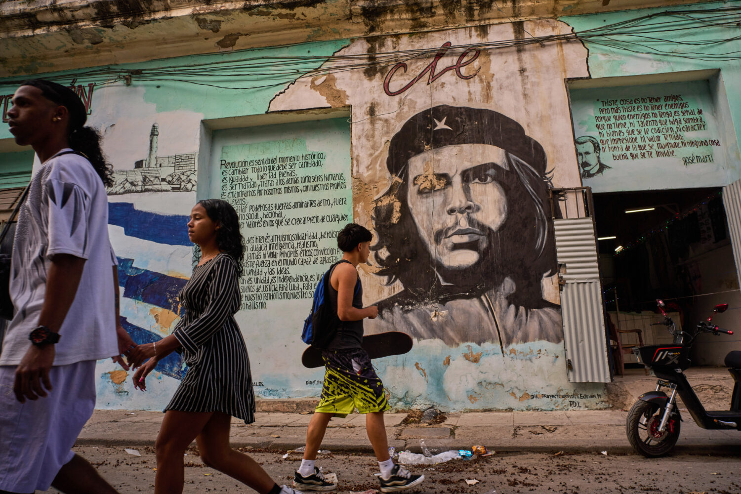 People walk past a mural of Che Guevara in Havana, Tuesday, Feb. 17, 2026. (AP Photo/Ramon Espinosa...