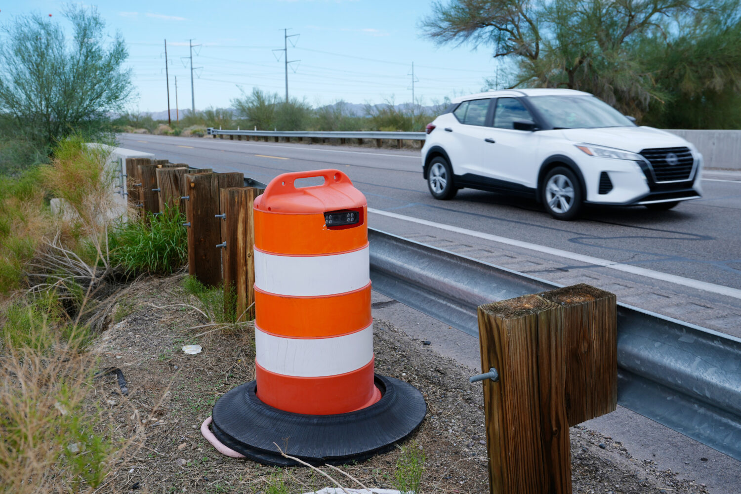 FILE - A license plate reader used by U.S. Border Patrol is hidden in a traffic cone while capturin...