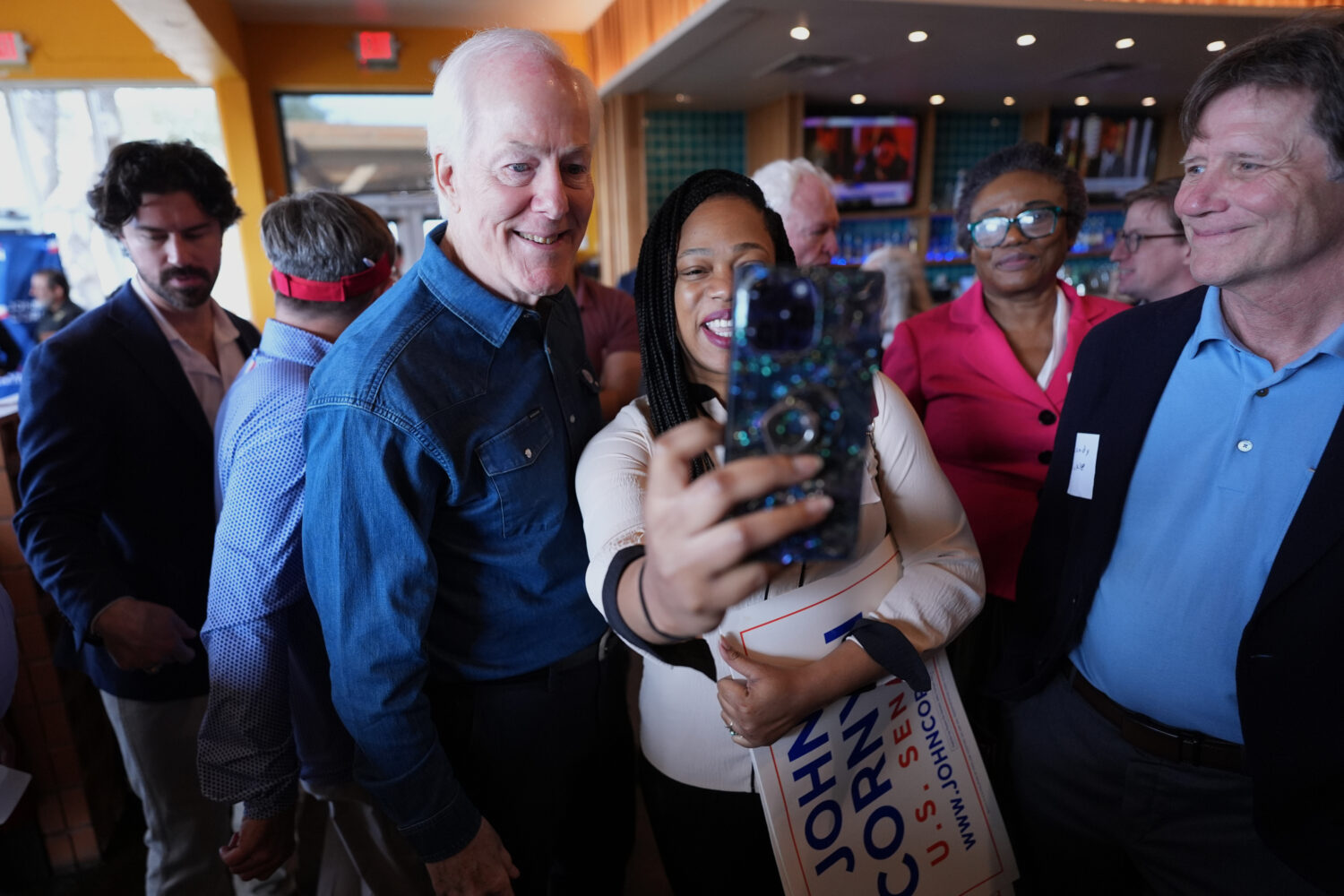 Sen. John Cornyn, R-Texas, left, poses for photos and visits with supporters during a campaign stop...