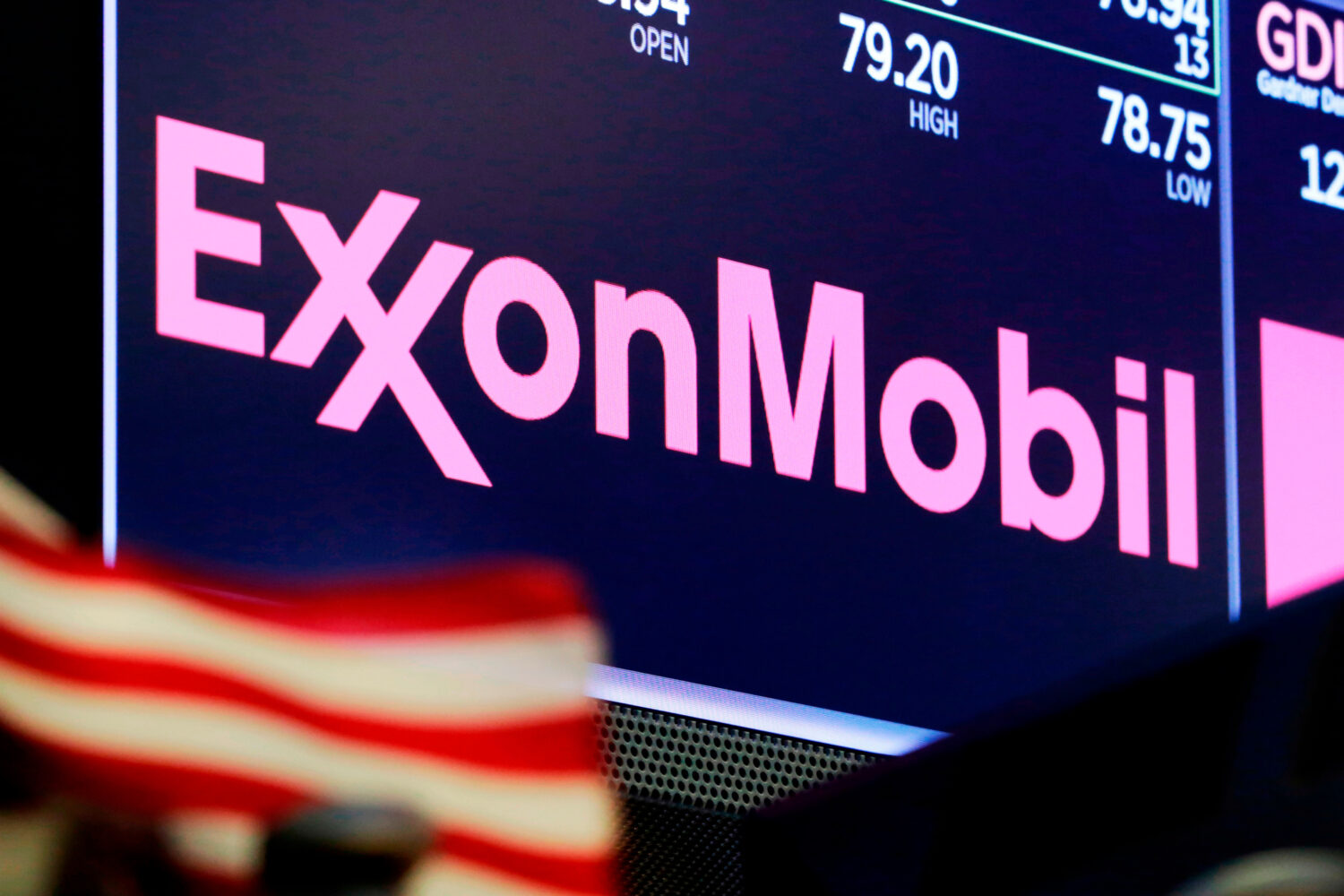 FILE - The logo for ExxonMobil appears above a trading post on the floor of the New York Stock Exch...