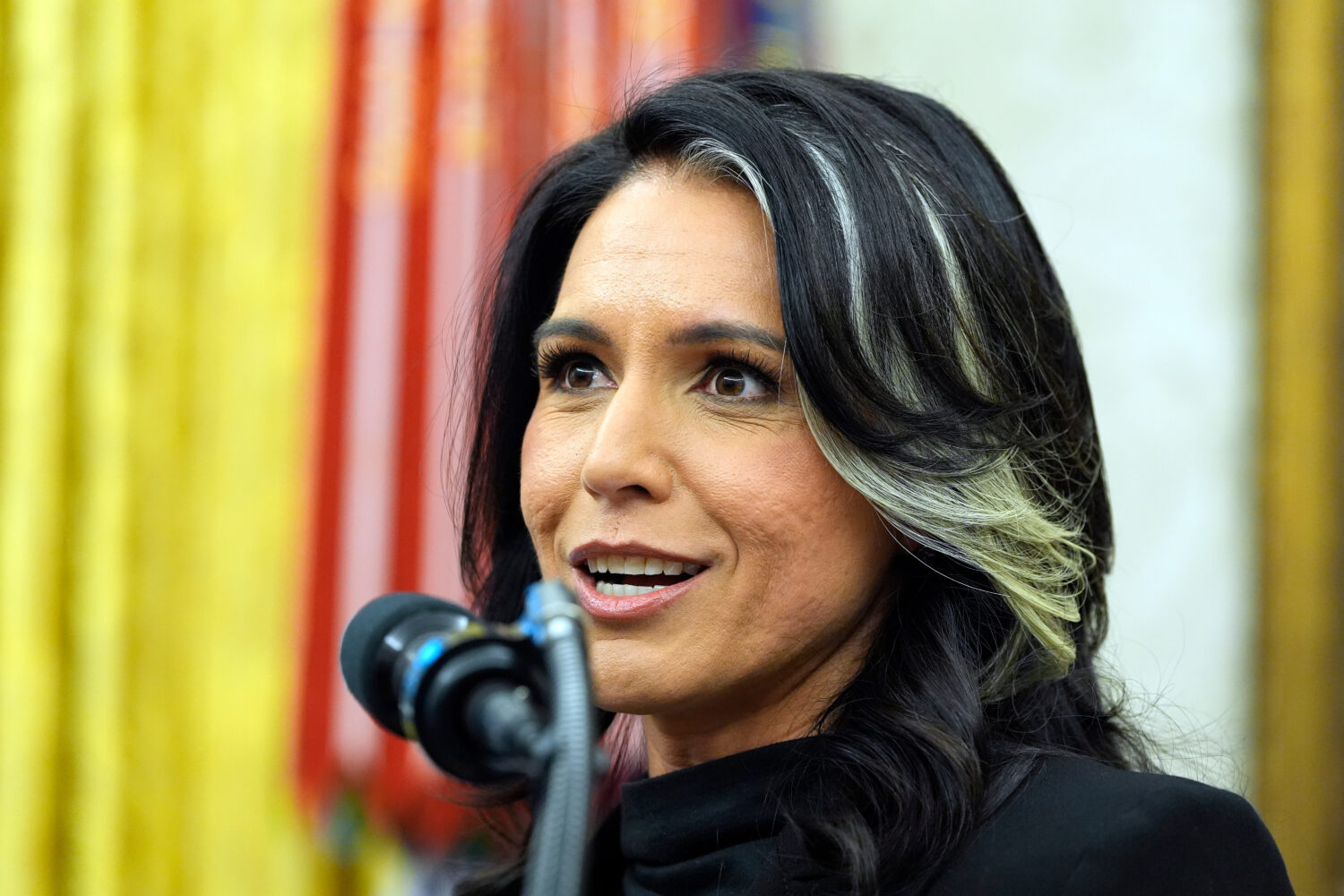 FILE - Tulsi Gabbard listens to President Donald Trump as she is sworn in as the Director of Nation...