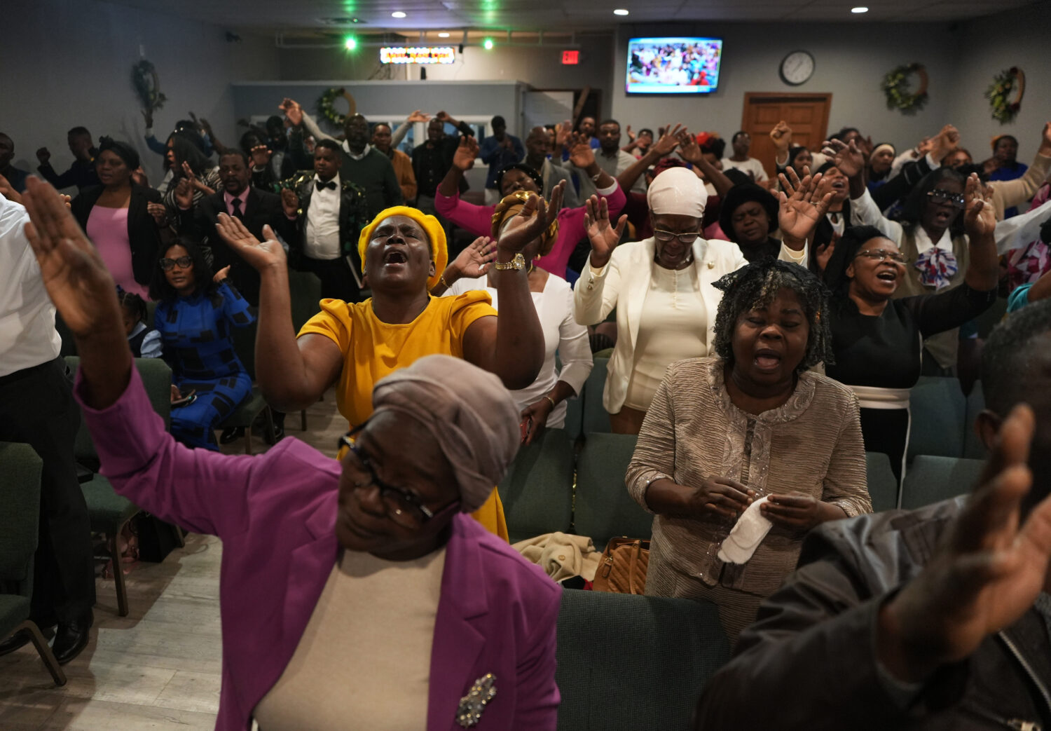 Congregants worship at the First Haitian Evangelical Church of Springfield, Sunday, Feb. 1, 2026, i...