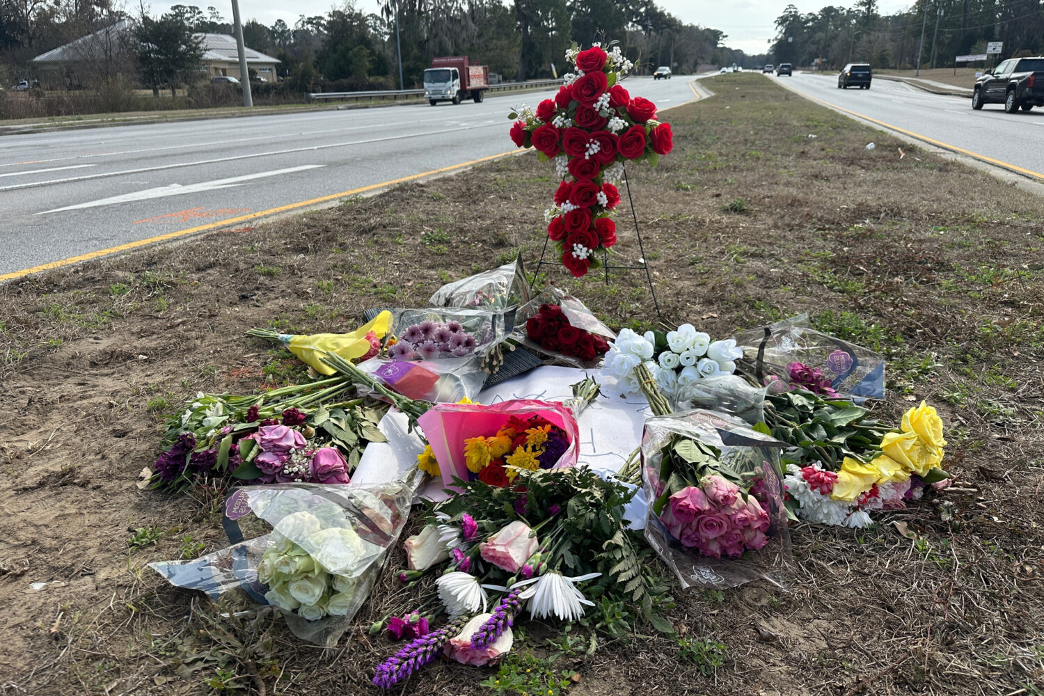 Flowers left in memory of Linda Davis lie by the roadway Thursday, Feb. 19, 2026, at the site outsi...
