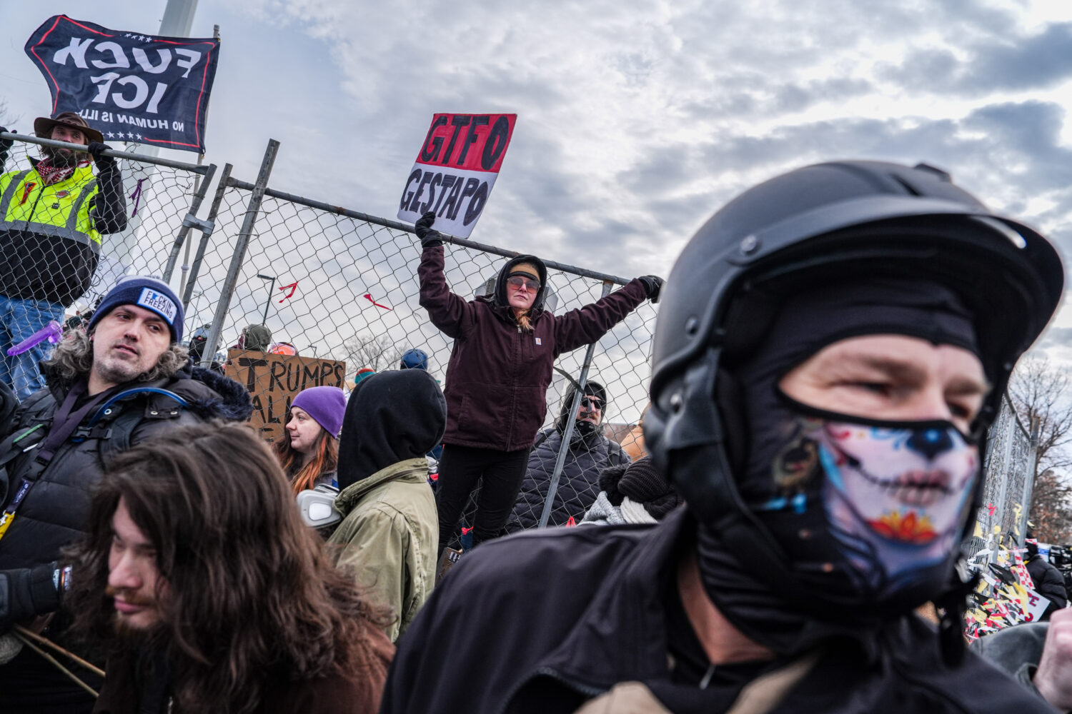 People attend an anti-ICE protest outside the Bishop Whipple Federal building in Minneapolis, Satur...