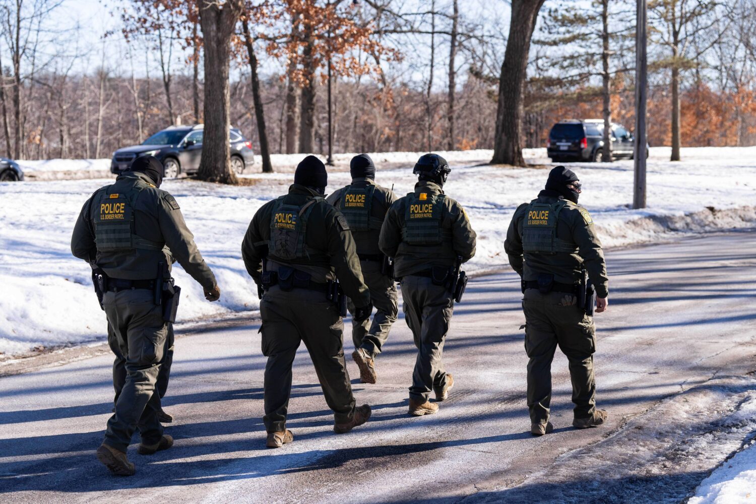 FILE - U.S. Border Patrol officers walk along a street in Minneapolis, Wednesday, Jan. 14, 2026. (A...