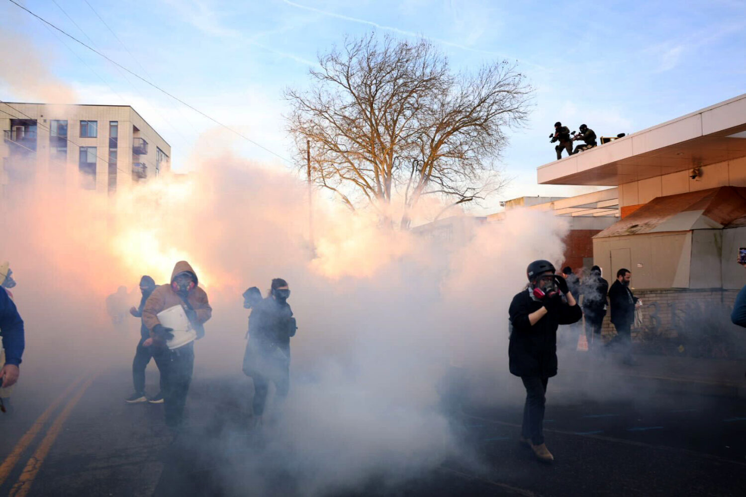 Federal agents lobbed tear gas and flash bangs at protesters in front of the ICE building on Jan. 3...