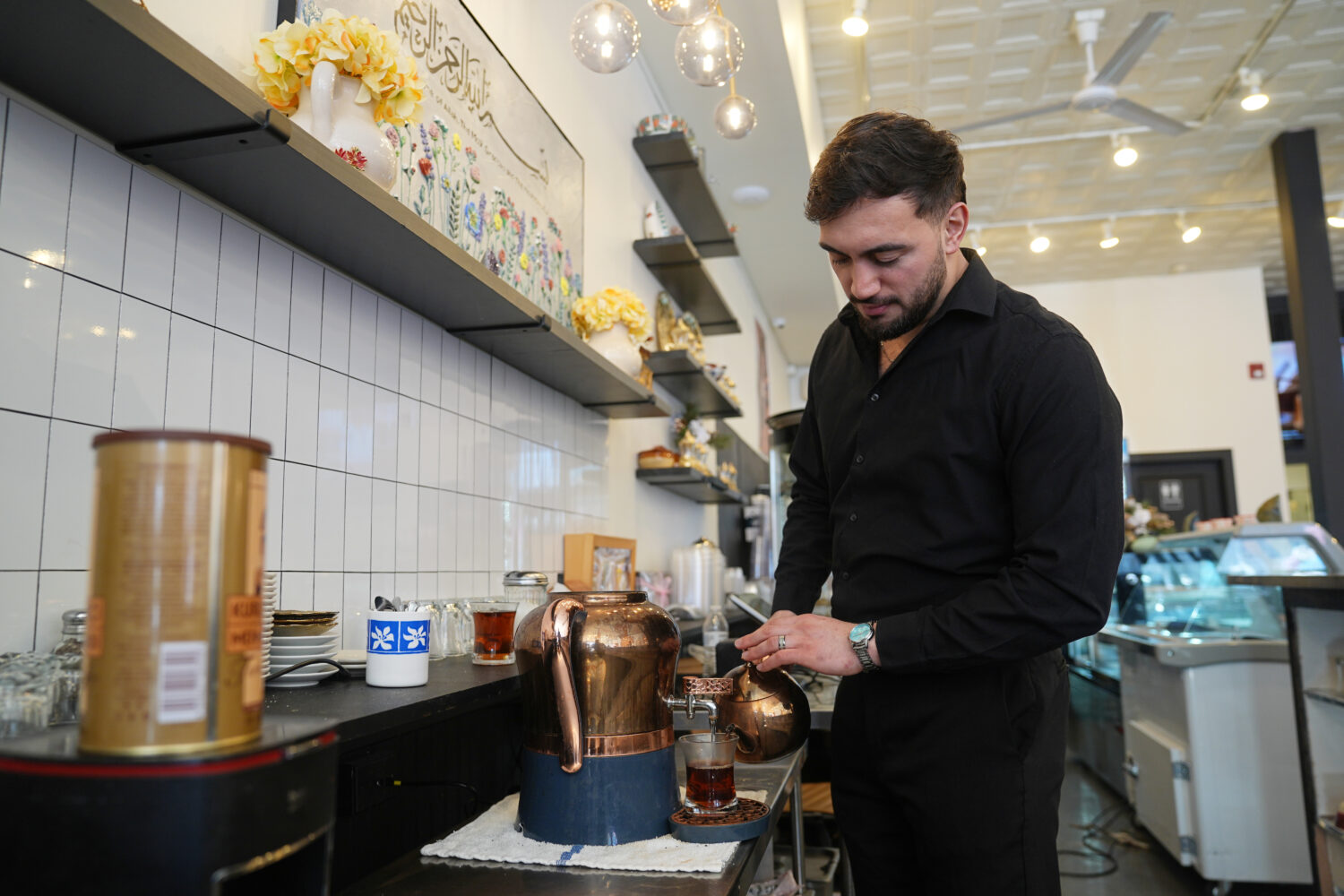 Muhammed Emanet pours Turkish tea for a guest at the Jersey Kebab restaurant, Thursday, Jan. 29, 20...