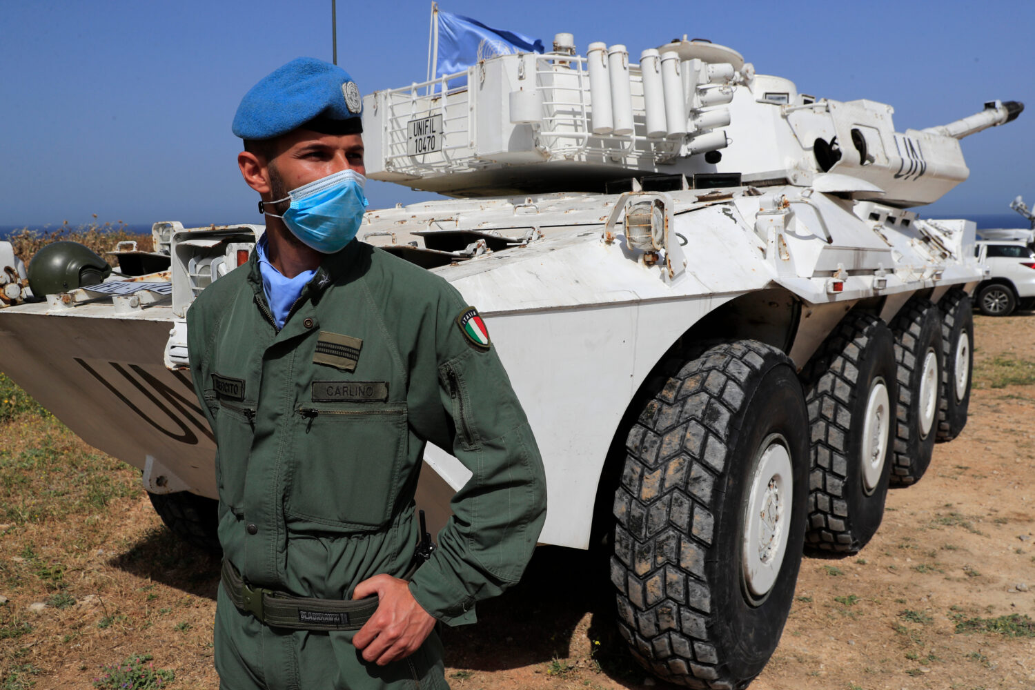 FILE - An Italian U.N. peacekeeper soldier stands guard at a road that links to a United Nations In...