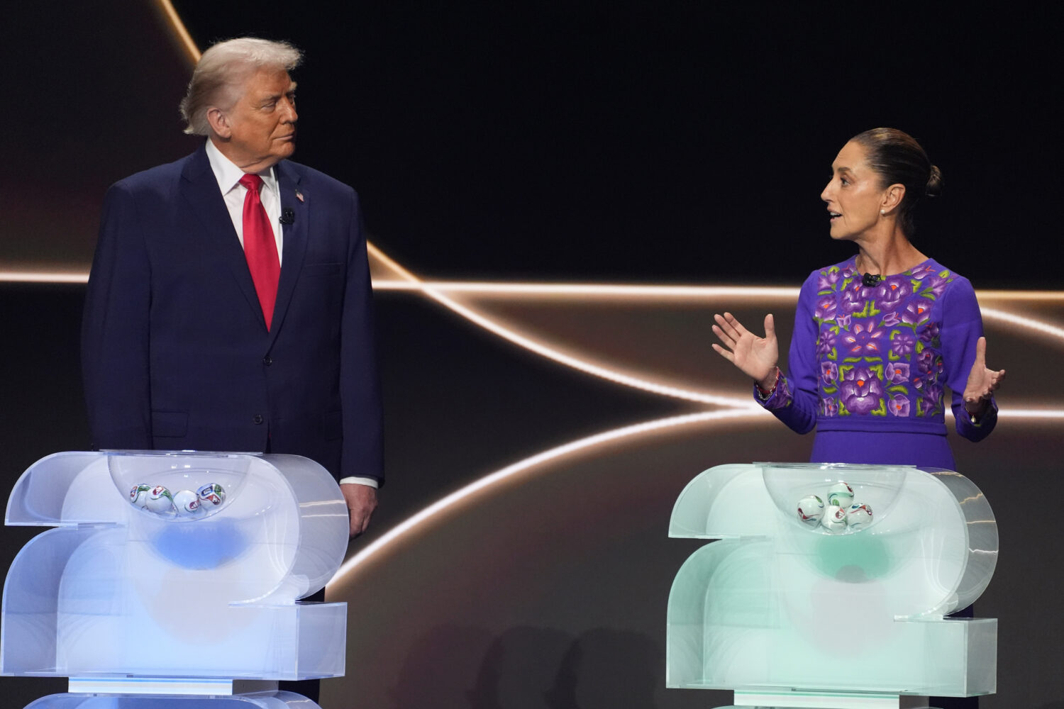 FILE - Mexican President Claudia Sheinbaum, right, speaks as President Donald Trump, left, stands o...