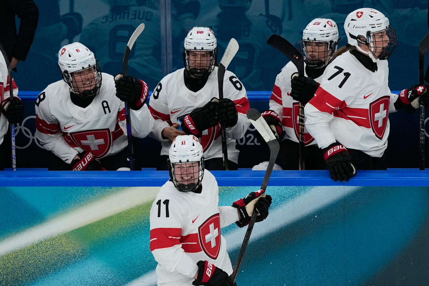 Switzerland's Laura Zimmermann, center, celebrates after scoring her side's opening goal during a p...