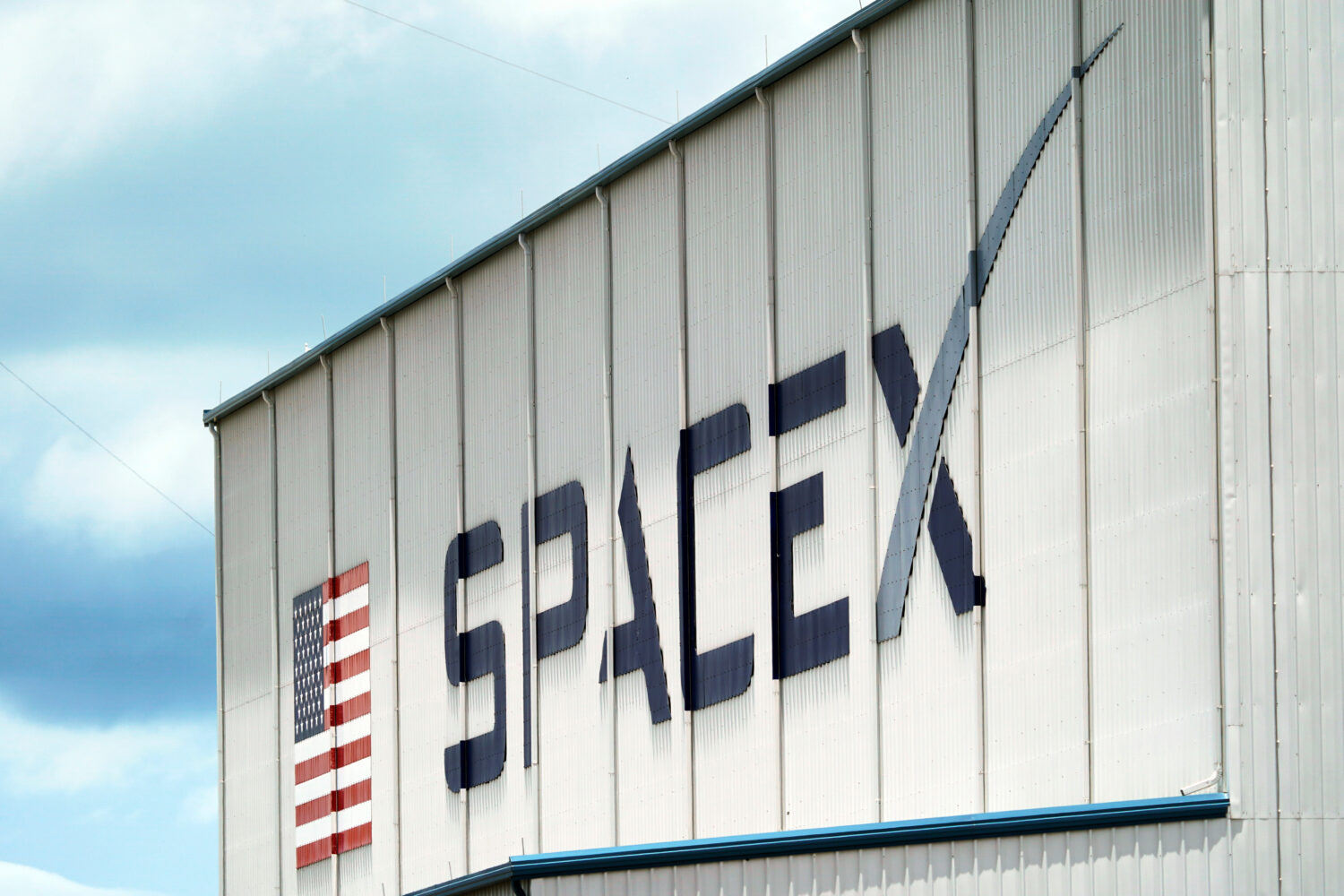 FILE - A SpaceX logo is displayed on a building, May 26, 2020, at the Kennedy Space Center in Cape ...