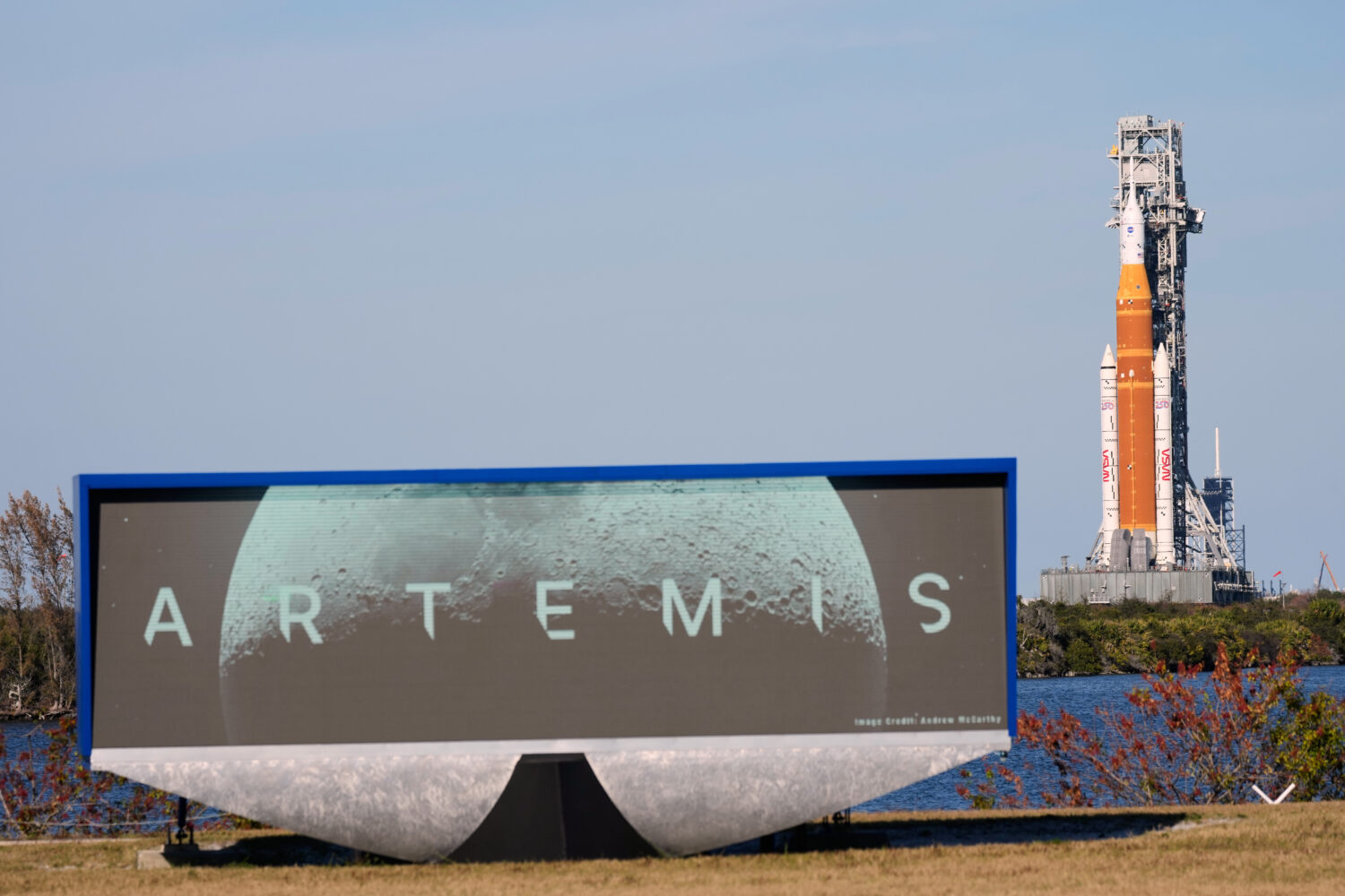 NASA's Artemis II SLS (Space Launch System) moon rocket with the Orion spacecraft slowly rolls back...