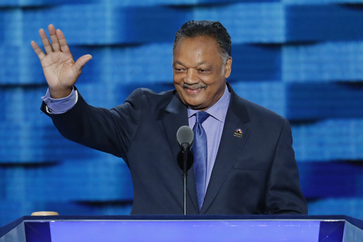 FILE - Rev. Jesse Jackson waves as he steps to the podium during the third day of the Democratic Na...
