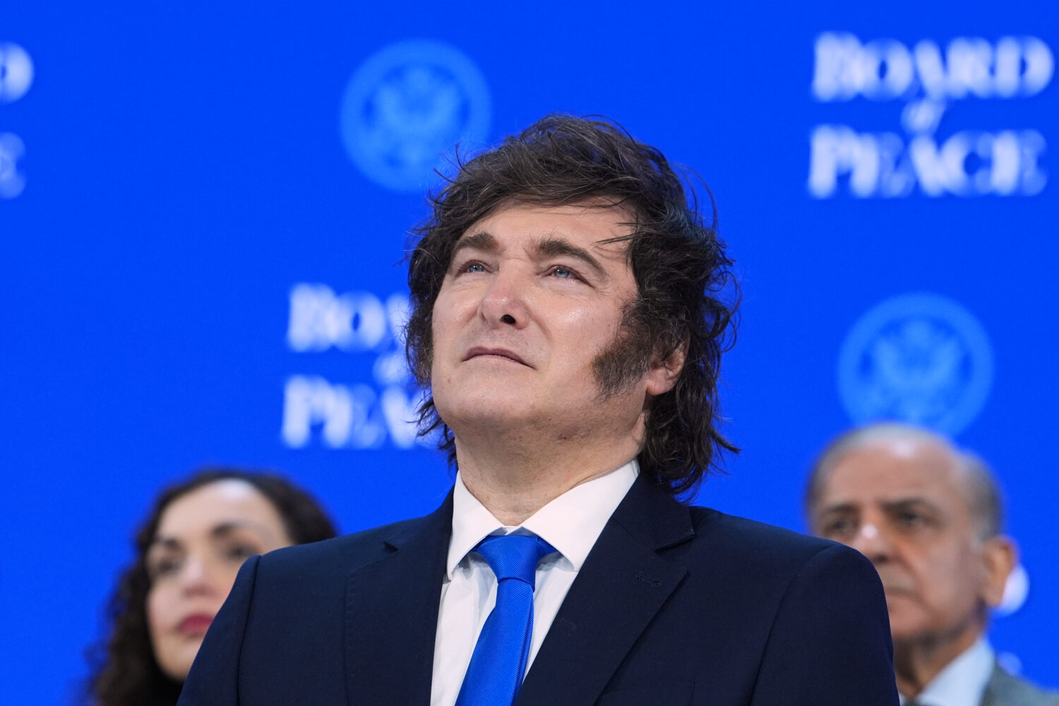 Javier Milei, President of Argentina, listens to speeches after the signing of a Board of Peace cha...