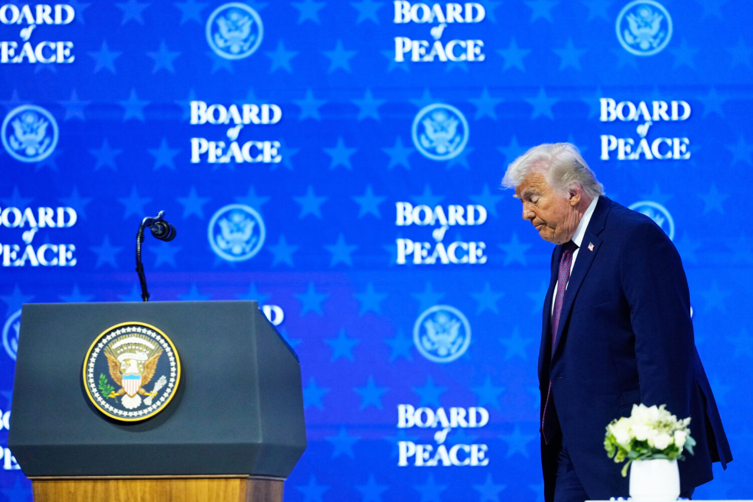 US President Donald Trump walks on the podium after a signing ceremony of his Board of Peace initia...