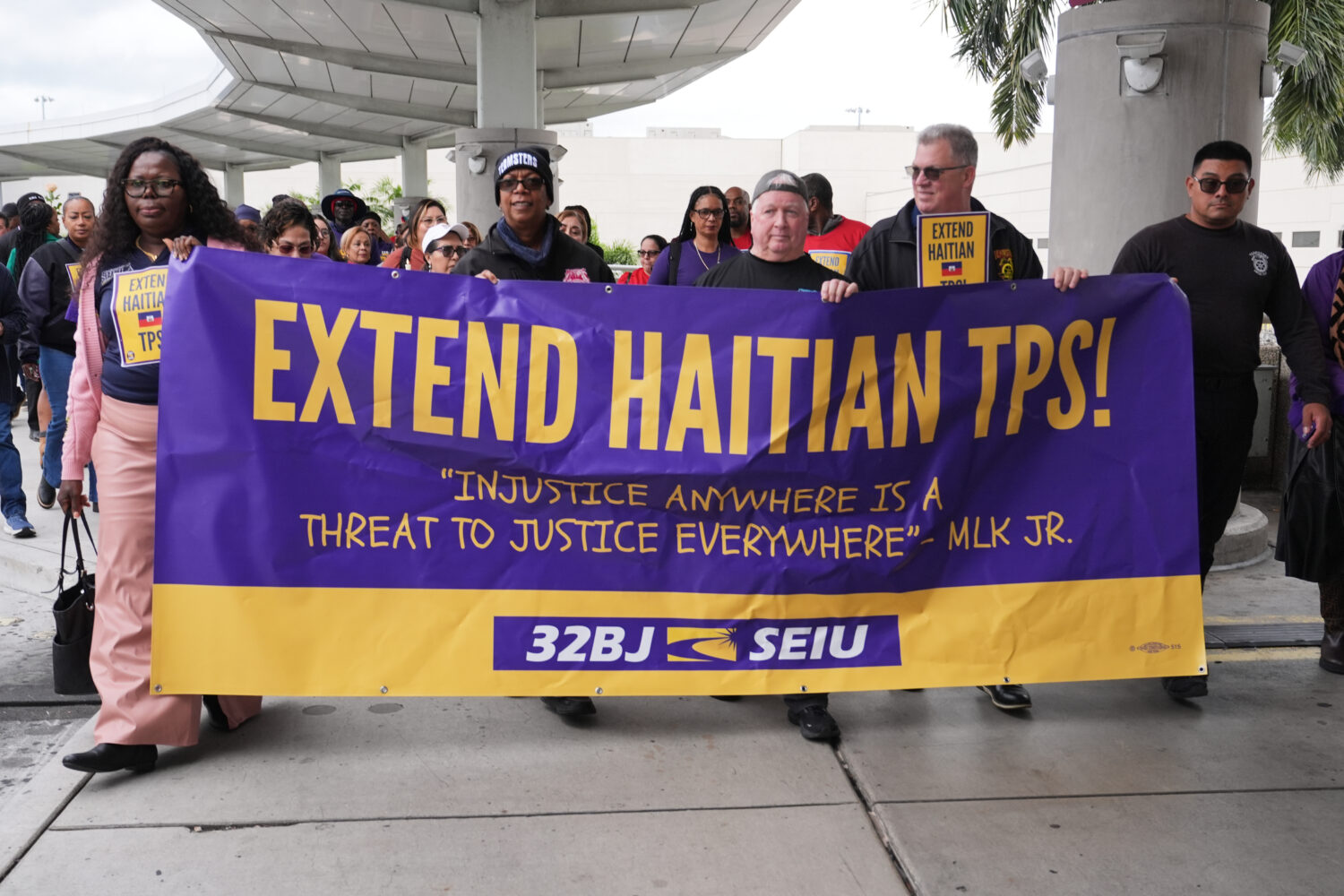 People march during a rally in support of the extension of Temporary Protected Status (TPS) for Hai...