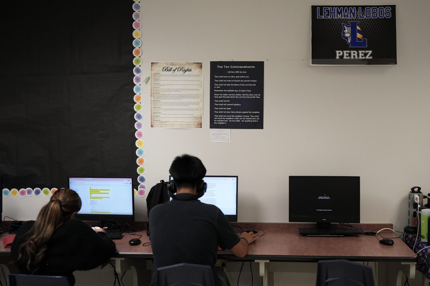 FILE - Students work under Ten Commandments and Bill of Rights posters on display in a classroom at...