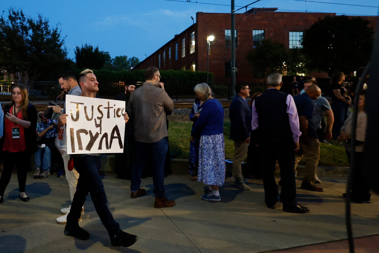 FILE - Michael Bermudez of Spartanburg, S.C., holds a sign at a vigil honoring the life of Iryna Za...