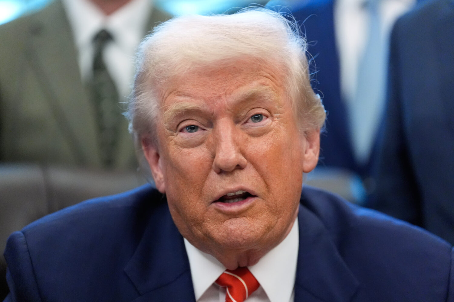 President Donald Trump speaks to reporters after signing a spending bill that ends a partial shutdo...