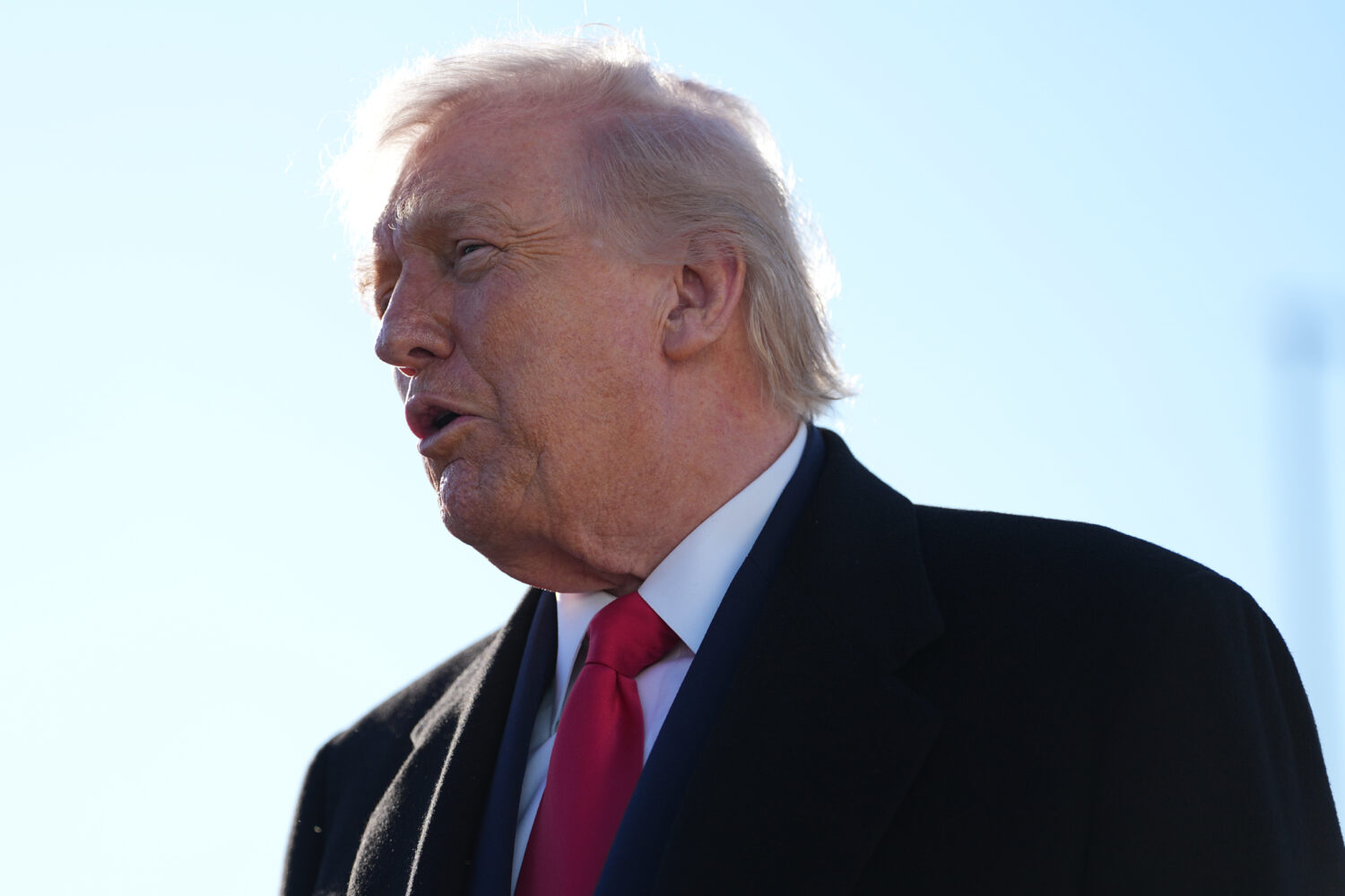 President Donald Trump speaks to reporters before boarding Air Force One at Pope Army Airfield, in ...