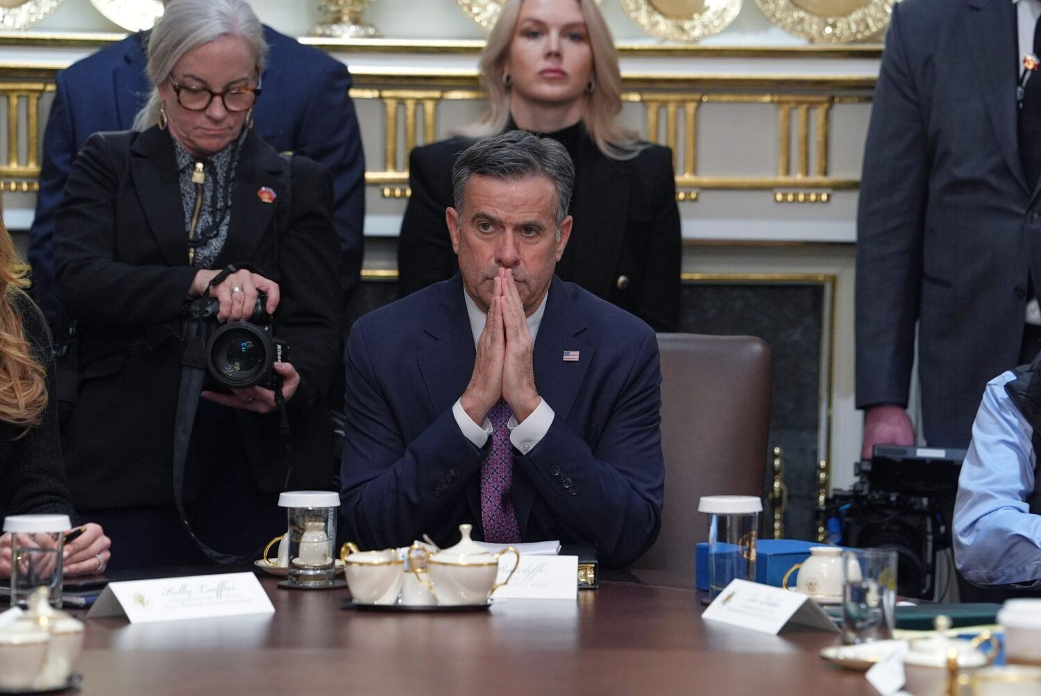 CIA Director John Ratcliffe, seated at center, and White House press secretary Karoline Leavitt, st...