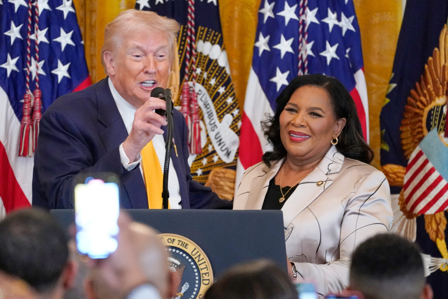 President Donald Trump speaks as White House pardon czar Alice Johnson listens during a Black Histo...