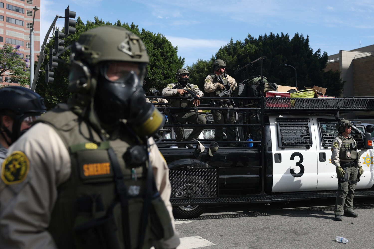FILE - Law enforcement officers stand guard during a protest, June 14, 2025, in Los Angeles. (AP Ph...